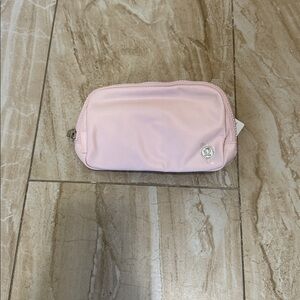 lululemon athletica pink beltbag 1L price tag removed, description tag attached
